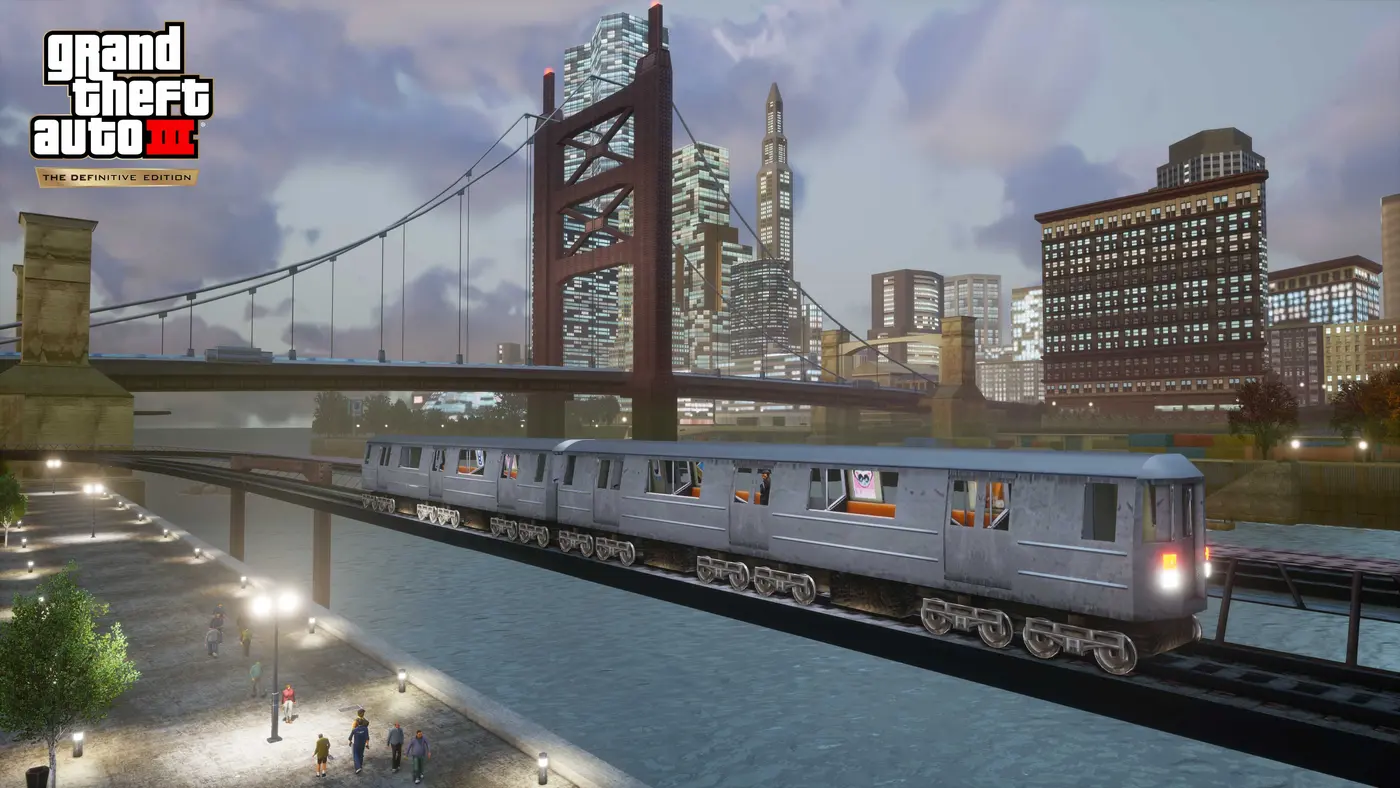 Capture officielle de GTA III The Definitive Edition : un métro aérien traverse un pont au-dessus de l'eau devant la skyline de Liberty City, pont suspendu et gratte-ciel sous un ciel nuageux