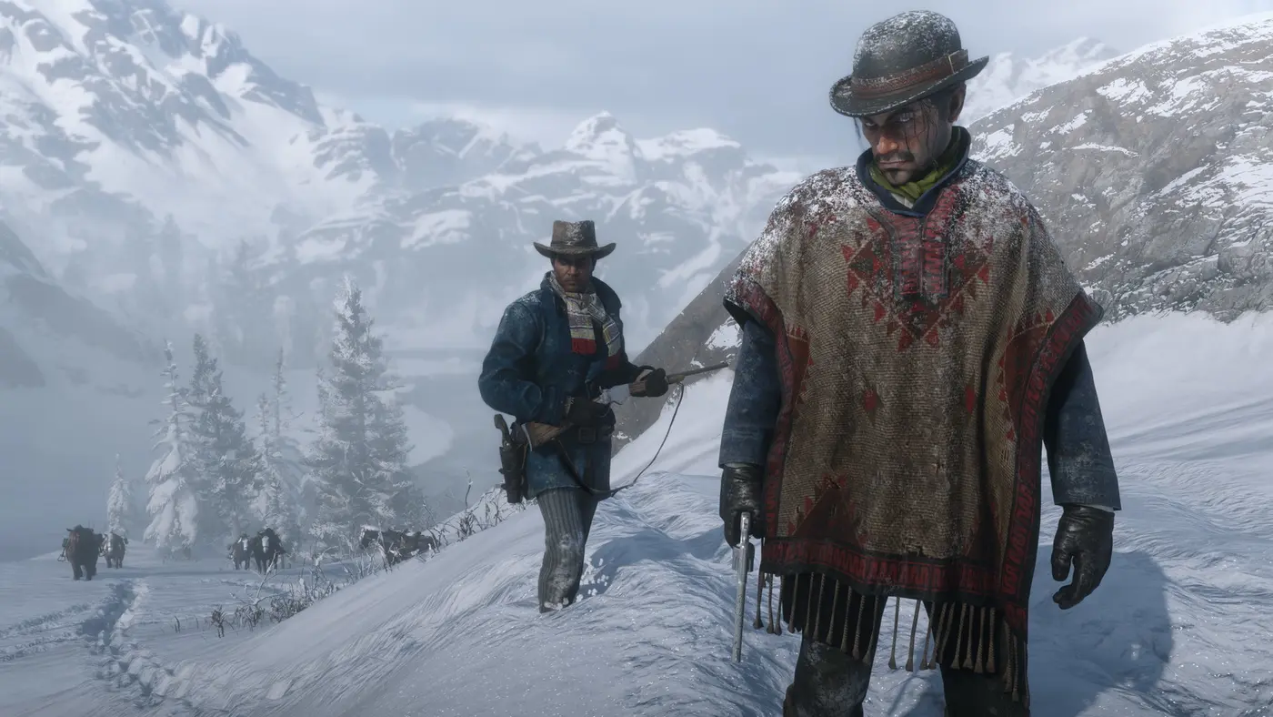 Capture officielle de Red Dead Redemption 2 : deux hommes progressent dans la montagne enneigée, neige et givre accrochés au poncho et au chapeau, empreintes de pas dans la poudreuse